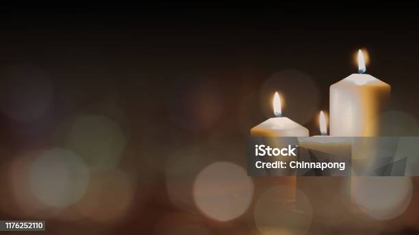 Christmas Advent Candle Light In Church With Blurry Golden Bokeh For Religious Ritual Or Spiritual Zen Meditation Peaceful Mind And Soul Or Funeral Ceremony Stock Photo - Download Image Now