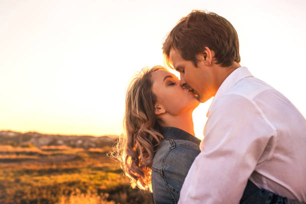 istock Loving couple is about kiss at sunset. 1176252119