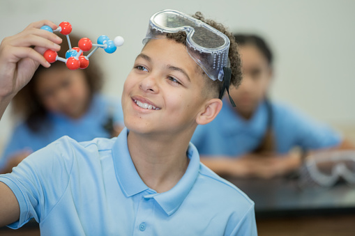 Preteen boy smiling in STEM science class