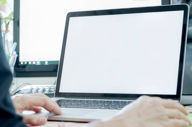 istock Closeup view man using laptop show blank screen while sitting at office desk. 1176253944