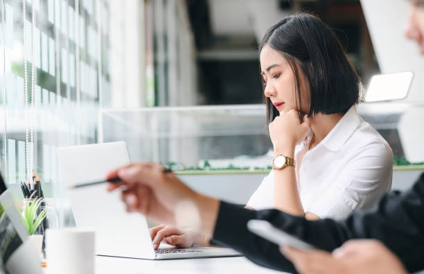 istock Young woman using laptop and thinking about job. 1176254065
