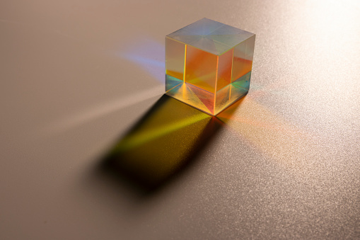 light go through three prisms with dark background