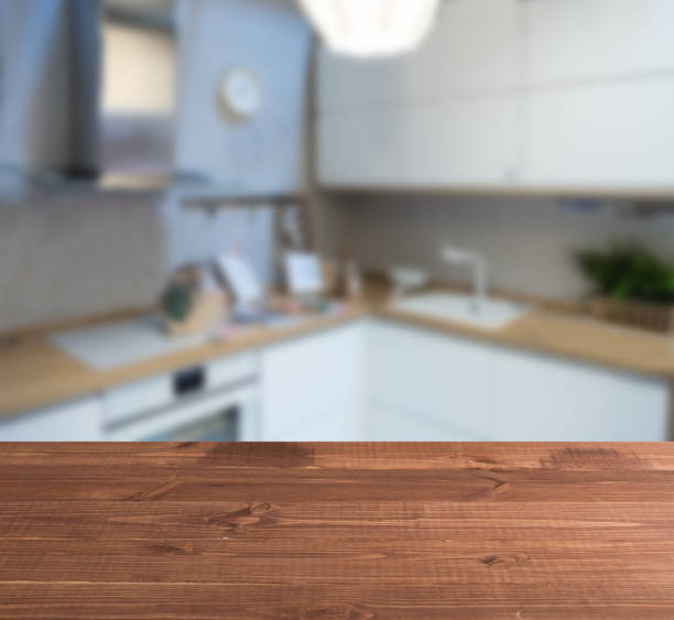 wooden table top and blur kitchen room of the background - domestic kitchen kitchen sink contemporary counter top imagens e fotografias de stock