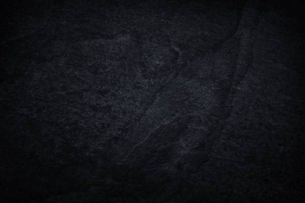 istock Dark grey black slate background or natural black stone texture. 1176269452