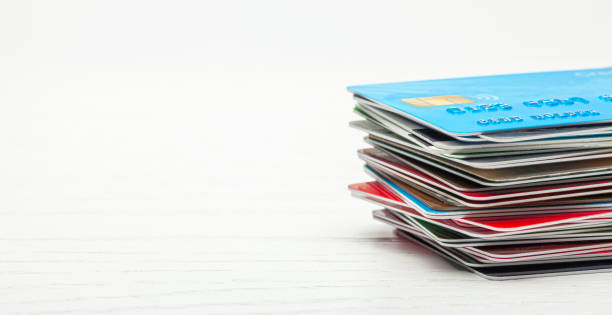 istock Stack of credit cards isolated on white wooden background 1176270497