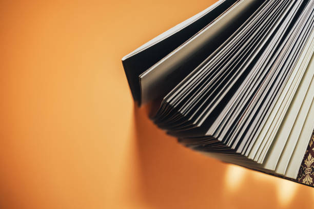 istock Close up Beautiful new book on a orange background. Top view. 1176271544