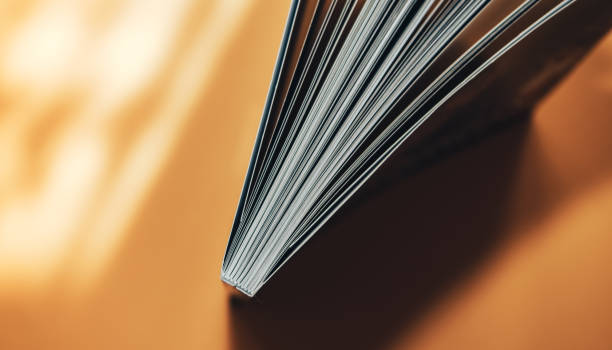 istock Beautiful new book on a orange background. Top view. 1176271599