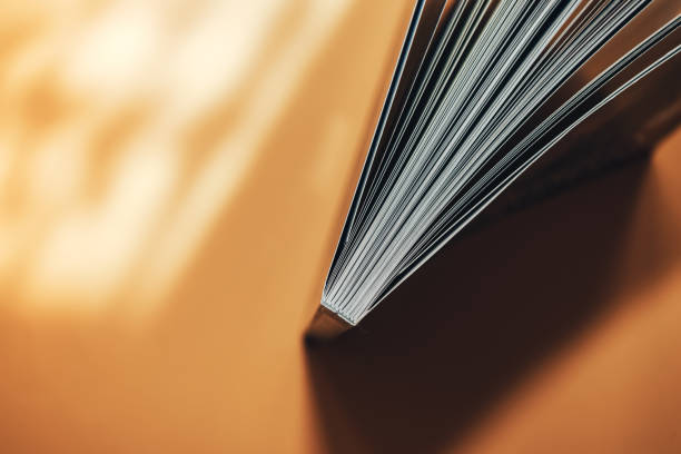istock Beautiful new book on a orange background. Top view. 1176271617