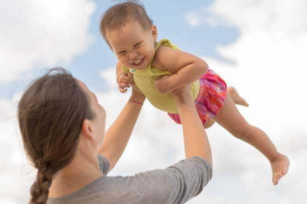 istock Mother playing outside with her baby. 1176272325