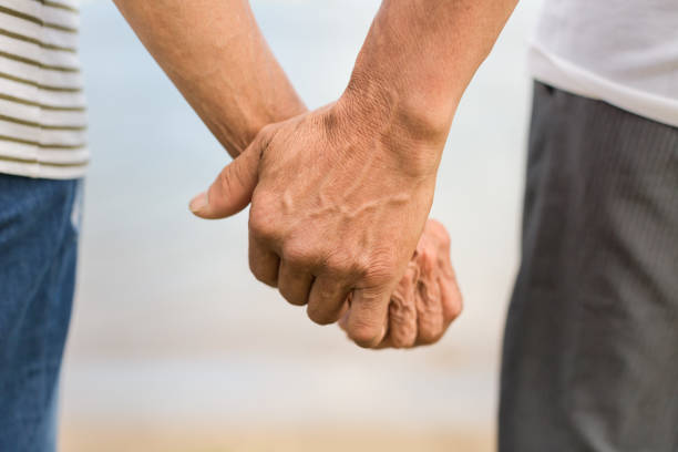 istock Old married man and woman holding hands. 1176272358