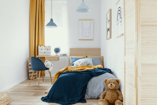 istock Multifunctional bedroom and workspace interior with bed and desk 1176274318