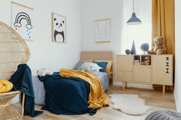 istock Stylish wooden commode in bright bedroom interior with poster on the wall 1176274326