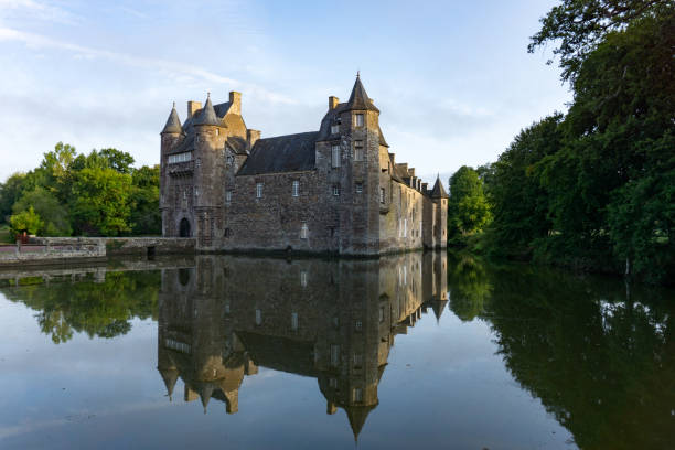 Campeneac, Brittany / France - 26 August 2019: Trecesson Castle in the pond and moat and surrounded by forest
