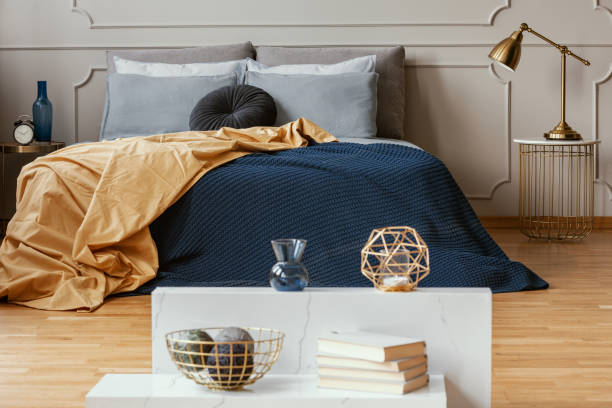 istock Knick knacks on console table in from of king size bed with comfortable bedding 1176275773