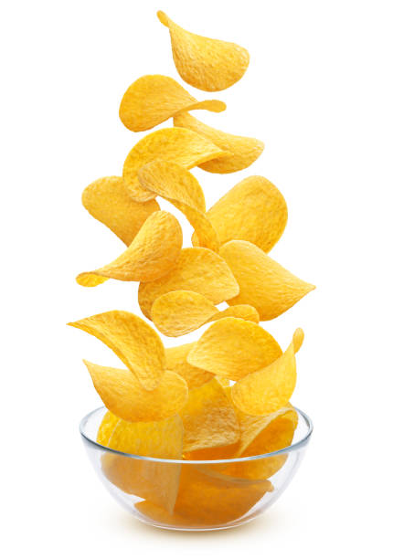 Delicious crispy potato chips pile in glass bowl