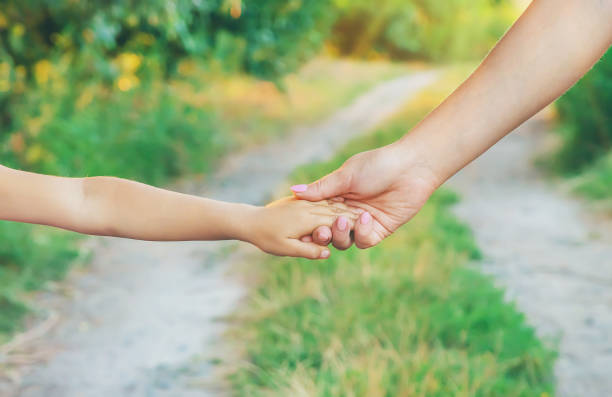 istock mother and child go by the hand. Selective focus. 1176280115