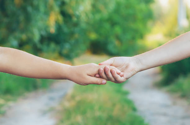 istock children hold hands together. People. Selective focus. 1176280119