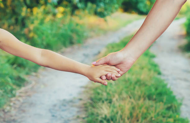 istock mother and child go by the hand. Selective focus. 1176280137