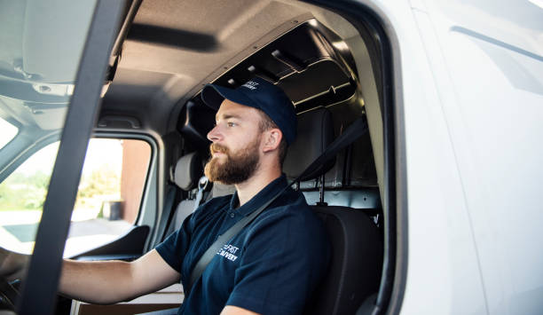 Delivery man sitting in a delivery van Delivery man sitting in a delivery van indigo truck stock pictures, royalty-free photos & images