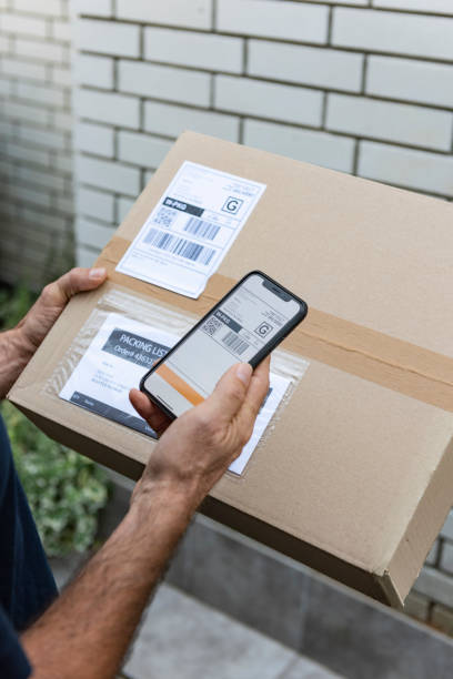 istock Delivery man scanning barcode on smart phone 1176281210