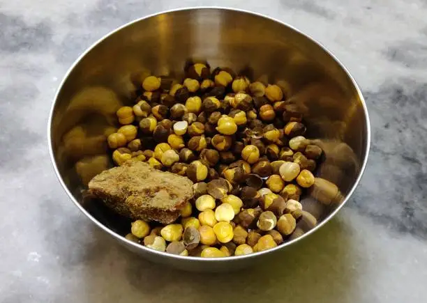 Roasted chickpeas in bowl with jaggery