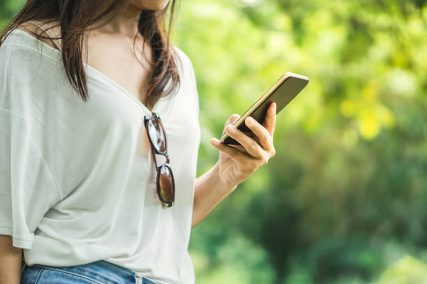 istock Asian female hipster hand using smart phone during traveling in forest 1176285738