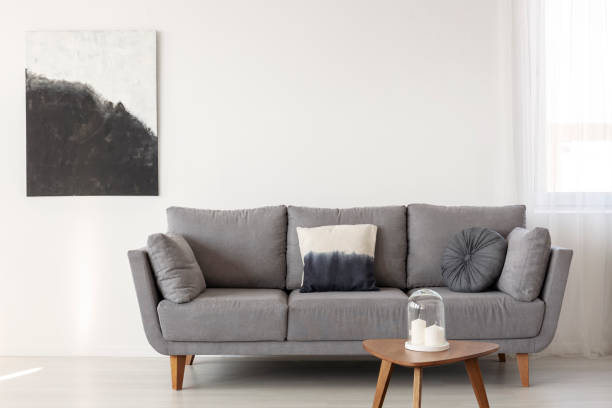 istock Grey scandinavian sofa in bright living room interior 1176285885
