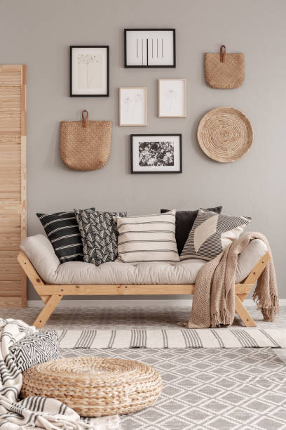 istock Beige scandinavian settee with patterned pillows in stylish living room interior 1176287664