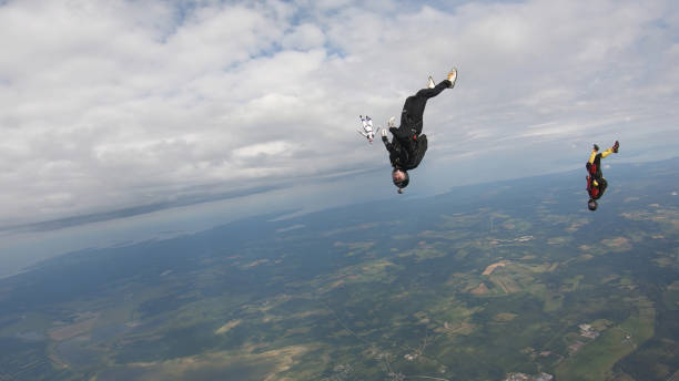 istock Skydivers fall through clear skies, in aerial flight 1176287969