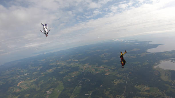 istock Skydivers fall through clear skies, in aerial flight 1176287970