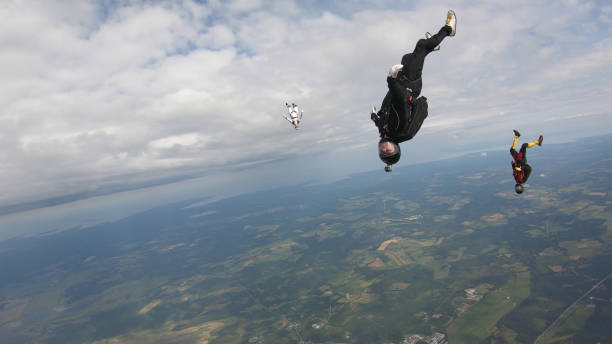 istock Skydivers fall through clear skies, in aerial flight 1176287989