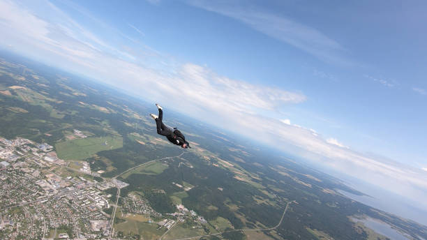 istock Skydiver falls through clear skies, in aerial flight 1176288011