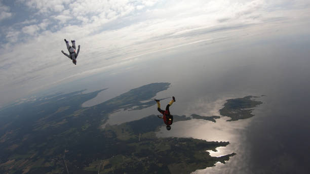 istock Skydivers fall through clear skies, in aerial flight 1176288014