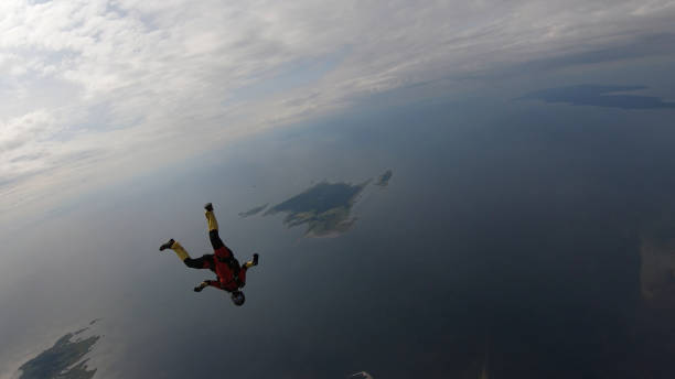 istock Skydiver falls through clear skies, in aerial flight 1176288033