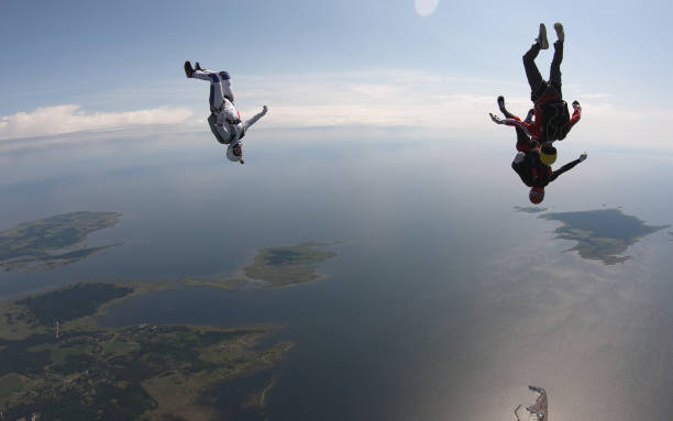 istock Skydivers fall through clear skies, in aerial flight 1176288039