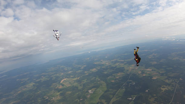 istock Skydivers fall through clear skies, in aerial flight 1176288043