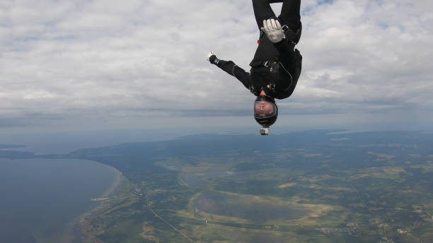 istock Skydiver falls through clear skies, in aerial flight 1176288061