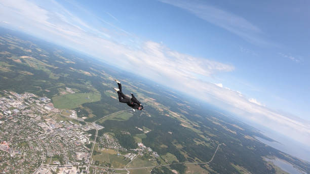 istock Skydiver falls through clear skies, in aerial flight 1176288064