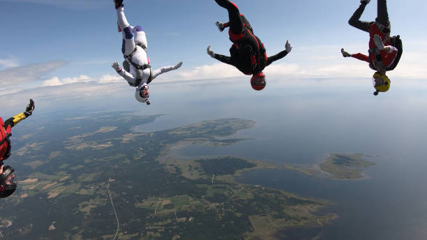 istock Skydivers fall through clear skies, in aerial flight 1176288114