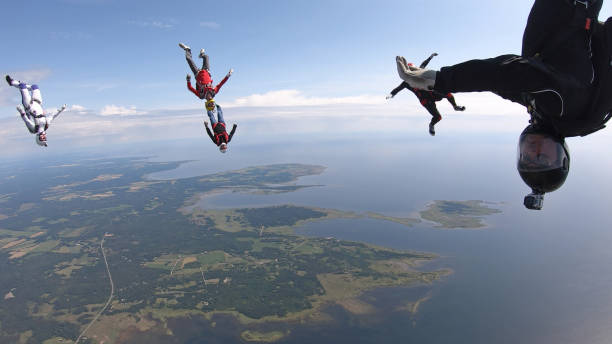 istock Skydivers fall through clear skies, in aerial flight 1176288115