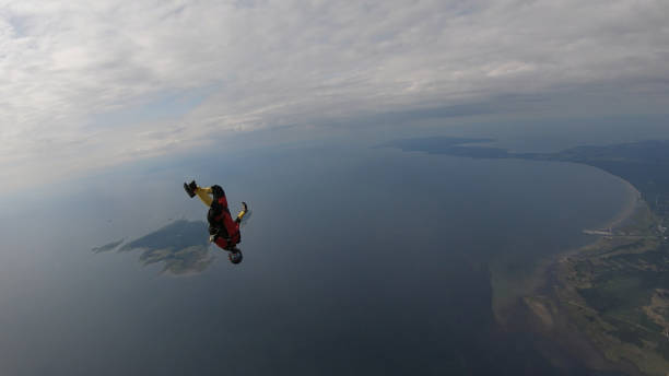 istock Skydiver falls through clear skies, in aerial flight 1176288156