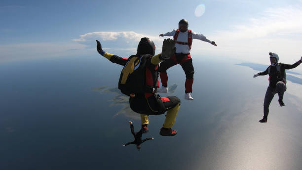 istock Skydivers fall through clear skies, in aerial flight 1176288208