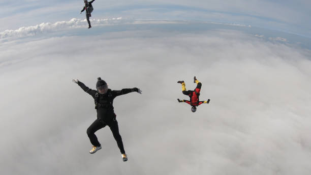 istock Skydivers fall through clear skies, in aerial flight 1176288229