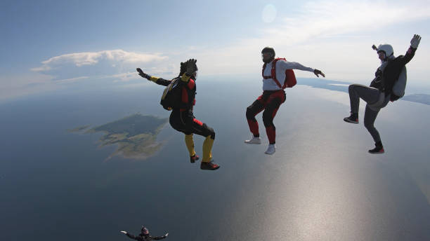 istock Skydivers fall through clear skies, in aerial flight 1176288249