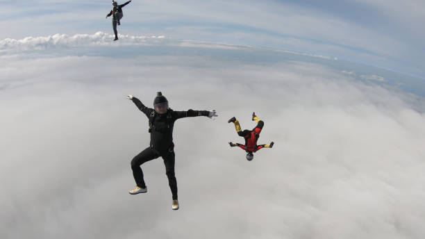istock Skydivers fall through clear skies, in aerial flight 1176288256