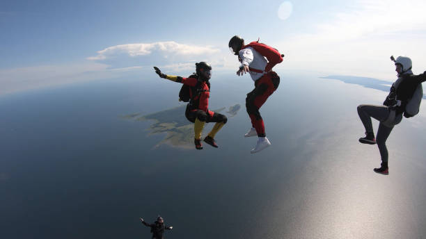 istock Skydivers fall through clear skies, in aerial flight 1176288268