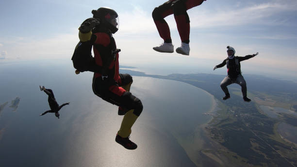 istock Skydivers fall through clear skies, in aerial flight 1176288273