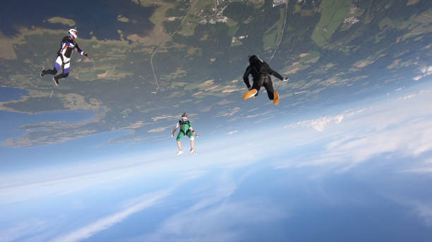 istock Skydivers fall through clear skies, in aerial flight 1176288277
