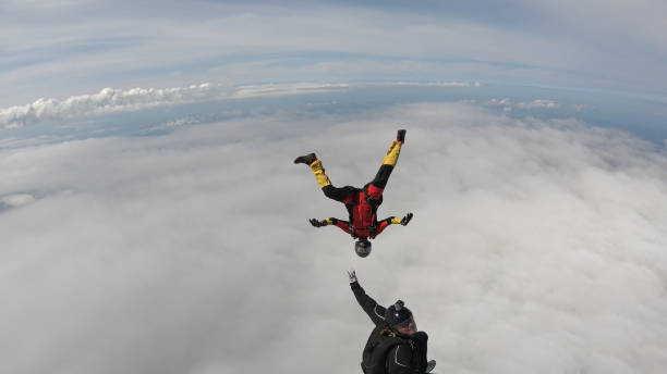 istock Skydivers fall through clear skies, in aerial flight 1176288784