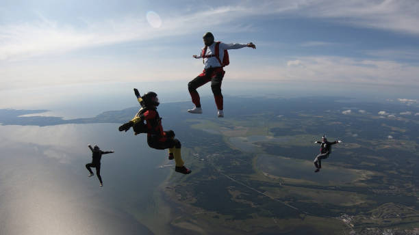 istock Skydivers fall through clear skies, in aerial flight 1176288792